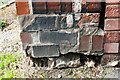 Damaged benchmark on corner wall pier at junction of Lismore Place and lane