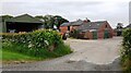 Wide Open Dykes buildings seen past farm entrance