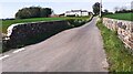 Rural road towards The Fauld crossing bridge over Hall Burn