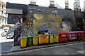 SJ8498 : Wheelie bins and a mural by Gerald England
