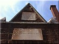 Plaques on wall of almshouses, Magdalen Street, Exeter