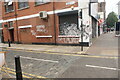 View of street art on the side of In-Focus Opticians on Jersey Street from Bethnal Green Road