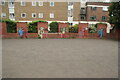 View of street art on the pillars of a brick wall around the edge of a car park off Graham Street