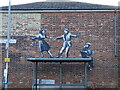 Banksy - Dancing in the street, on a bus shelter