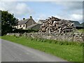 Cottage and log pile at Shotleyfield