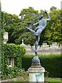 Statue of Hermes in walled garden