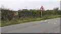 Former fieldgate and bend sign on NW side of rural road SW of Carleton Hill Cottages