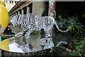 View of a tiger made of neon lights outside the Apple Market in Covent Garden