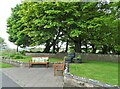 NZ1154 : Sitting area outside the churchyard by Robert Graham