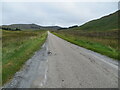 NC2512 : Road (A837) and moorland by Peter Wood
