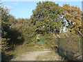 SS8380 : Kissing gate by public footpath at the edge of Cornelly Quarry by eswales