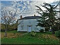 Browhill farmhouse with roofer at work