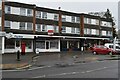 Parade of shops on Station Road, with flats above