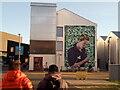 View of a mural on the side of an office building on East Bay Lane