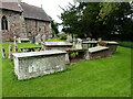 SJ5512 : Group of chest tombs in the churchyard of St Lucia at Upton Magna by Richard Law