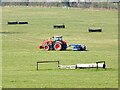 SK5013 : Rolling the grass in a field of horse jumps by Ian Calderwood