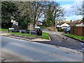 Four containers on grass at a junction in Caerleon