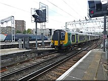 TQ2982 : Trains pass at Euston Station by Roger Cornfoot