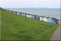 TR1167 : View of a row of beach huts and the Isle of Sheppey from Tankerton Slopes by Robert Lamb