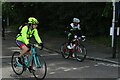 View of cyclists in the RideLondon event turning the corner from Broadmead Road into High Road Woodford Green