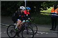 View of cyclists in the RideLondon event turning the corner from Broadmead Road into High Road Woodford Green #2