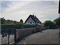 Thatched cottages viewed over the school yard