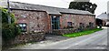 Barn conversion on SW side of road at north end of Newton Reigny