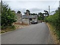 Cyclists passing a house near Portfield