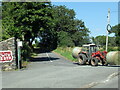 SH8528 : Tractor with bales of hay waiting to join the A494 north by Roy Hughes