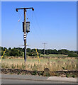 Electricity transmission line and a boundary stone, Denholme Gate Road (A644)