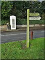 Signpost and cream telephone kiosk in Welton