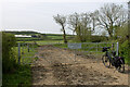 A power assisted bicycle in front of a gate bearing the words 