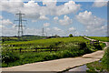 Pylons carrying overhead cables past buildings on Little Stone Farm