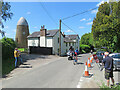 Clavering: a racing cyclist passing Mill End