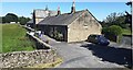 Knowles Cottages on NE side of A682