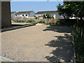 A gravel court outside the hall