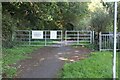 Gates on track into private woodland