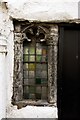 A stained glass window in the wall of the Ship Inn, Porlock