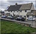 Houses and cars opposite the churchyard, Coaley, Gloucestershire