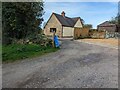 Footpath stile and new-build cottages