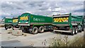 Aggregate lorries on riverside wharf