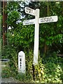 Sign post and mile post next to Chequers Inn