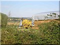 Driver covering up the combine harvester Langley