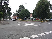 SJ7990 : Mini roundabout and shops by Dave Smethurst