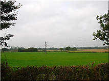TQ5308 : Electricity Pylons and farmland by Simon Carey