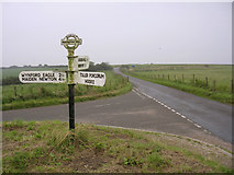 SY5494 : Road junction and signpost on Eggardon Hill by Jim Champion