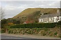 A house by the roadside and china clay waste tip