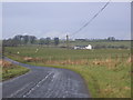 Fell road with farm in background.