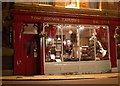 Night Time View of a Traditional Tailors Window.