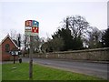 TL6408 : Village sign and church, Roxwell by John V Nicholls